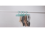 Socks drying on a teal sock hanger.