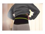 Person wearing a black and neon green back support belt over gray leggings.