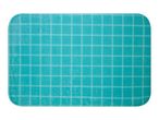 A teal self-healing cutting mat with a grid pattern.