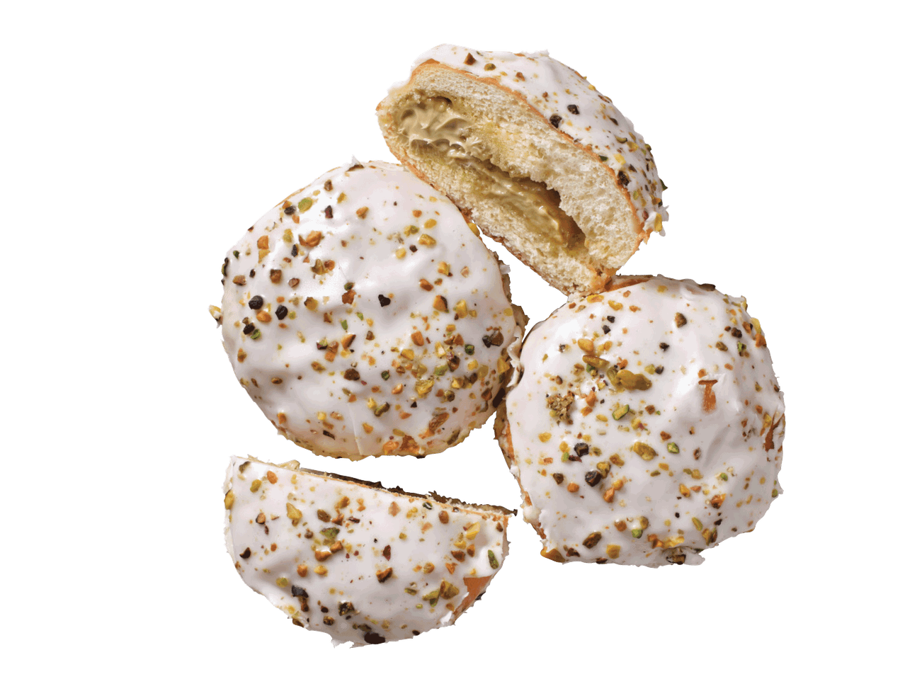 Donuti ar baltu glazūru un pistāciju drumstalām, viens pārgriezts uz pusēm ar pildījumu.