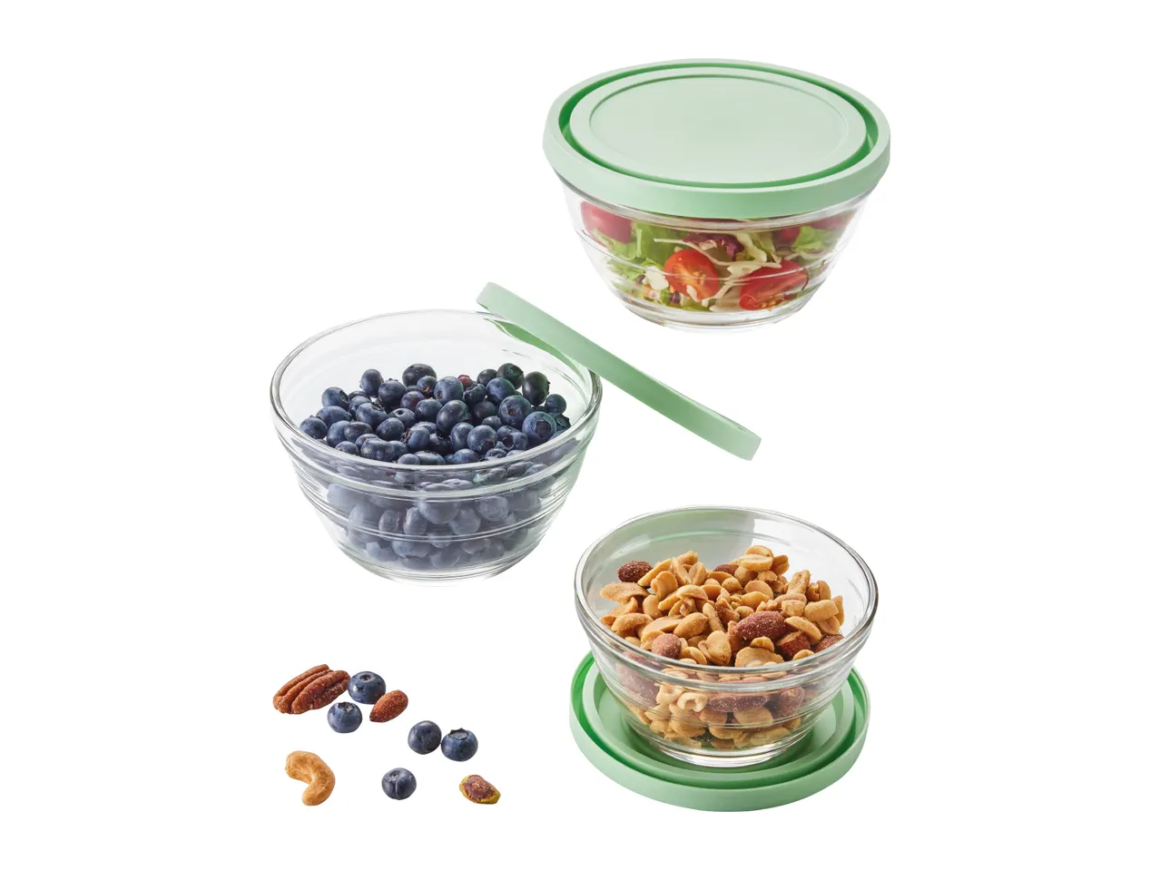 Glass food storage containers with lids, filled with blueberries, nuts, and trail mix.