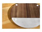 Round wooden and marble serving board on a wooden surface.
