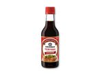 En flaske teriyaki marinade med et billede af grillet kød og salat på etiketten.
