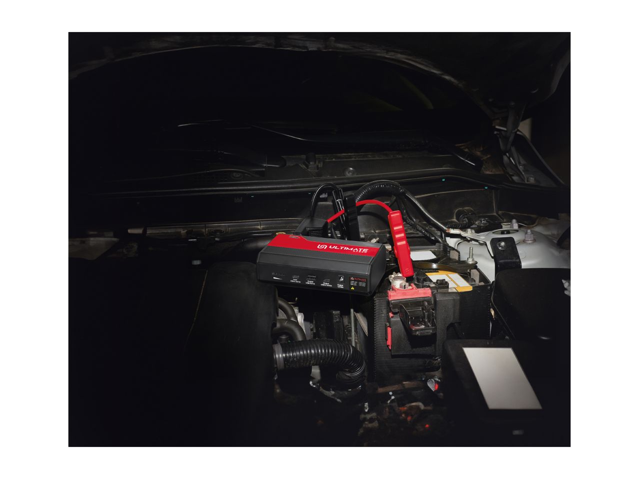 ULTIMATE Speed jump starter connected to a car battery under the hood