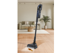 SILVERCREST® Cordless Cyclone Handheld Vacuum Cleaner cleaning a spill on a wooden floor.