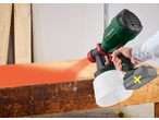 PARKSIDE 20V Cordless Paint Sprayer painting a wooden surface orange.