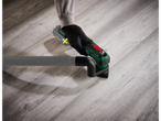 Parkside 20V Cordless Multi-Tool with dust extraction hose on a wooden floor