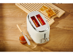 SILVERCREST® toaster with toast and jam on a wooden table.