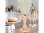 Cake, rose gold champagne dispenser, and glasses for a celebration.