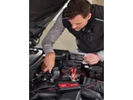 Man charging a car battery with an ULTIMATE SPEED® Car & Motorcycle Battery Charger.
