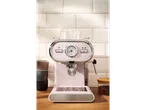 A pink SilverCrest espresso machine sits on a wooden counter in front of a white tiled backsplash.