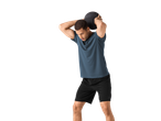 Homem de t-shirt e calções desportivos Crivit, segurando uma bola medicinal acima da cabeça.