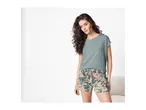 Woman in a green t-shirt and floral shorts