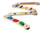 Wooden zigzag balance beam with colorful geometric shapes for children's play.