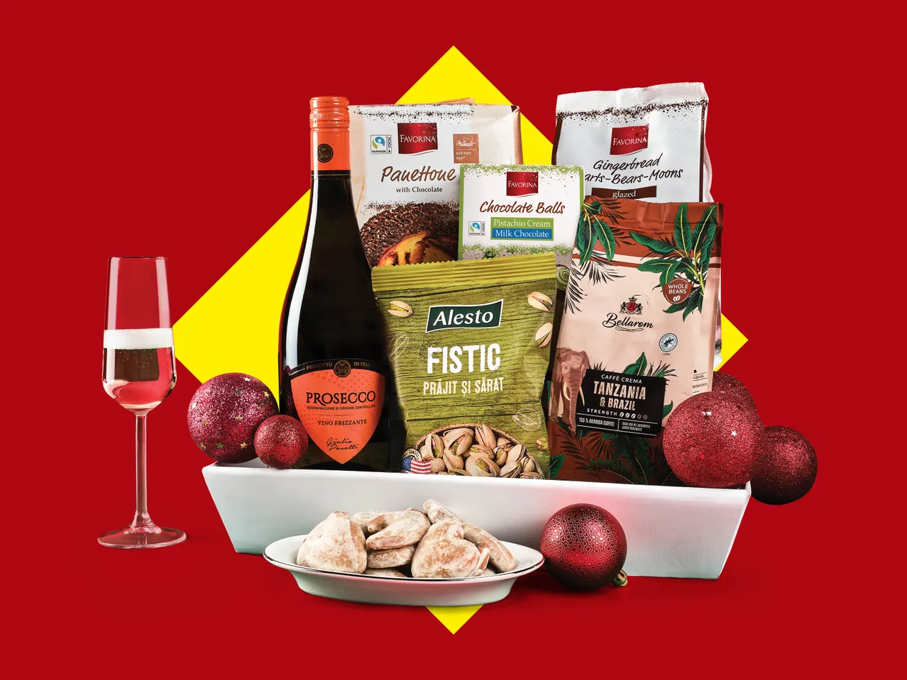 Coș cadou cu Prosecco, panettone, biluțe de ciocolată, turtă dulce, fistic și cafea.