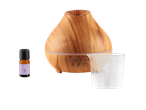 Wooden essential oil diffuser, SilverCrest lavender oil, and measuring cup.