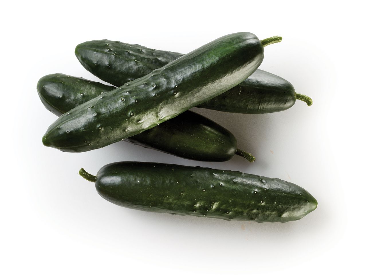 Four dark green cucumbers on a white background.