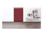 A room with white walls, a red patterned accent wall, and two white floating shelves with decor.