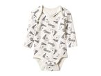 White long-sleeved baby bodysuit with black Peanuts characters and text.