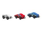 Three wooden toy race cars in white, red, and blue with numbers 4, 28, and 12.
