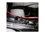 A red cable secured with a black zip tie under a car hood.