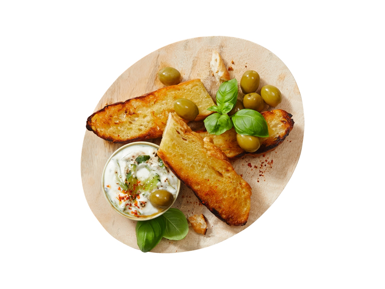 Bread, olives, and dip on a wooden board.