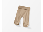A pair of light brown baby footed pants with a wide waistband.
