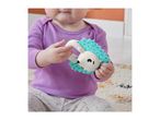 Baby in a purple top holding a hedgehog-shaped teether with blue spikes.