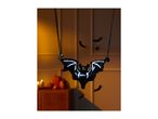 Halloween bat balloon with pumpkins and candles in a dimly lit room.