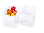 Two white plastic storage bins; one contains fruit.