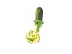 A zucchini being spiraled using a vegetable peeler.