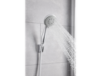 Modern chrome shower head running in a bathroom.