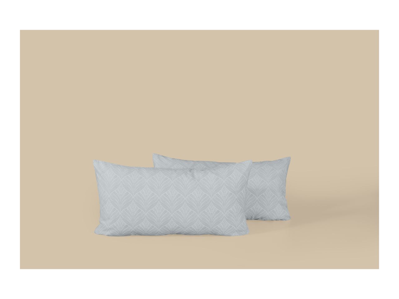 Two light grey pillows with a subtle leaf pattern on a beige background.
