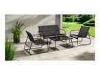 Black outdoor lounge set with a two-seater sofa, two armchairs, and a glass-top coffee table on a patio.