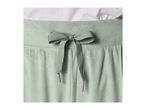 Close-up of light green velvet sweatpants with a tied drawstring.