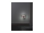 A wall-mounted USB charging outlet with an illuminated ring in a modern room.