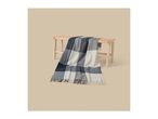 A plaid throw blanket in shades of blue, grey, and white draped over a wooden bench.