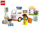 Toy ambulance, two figures, and building blocks, including a house and first aid supplies.