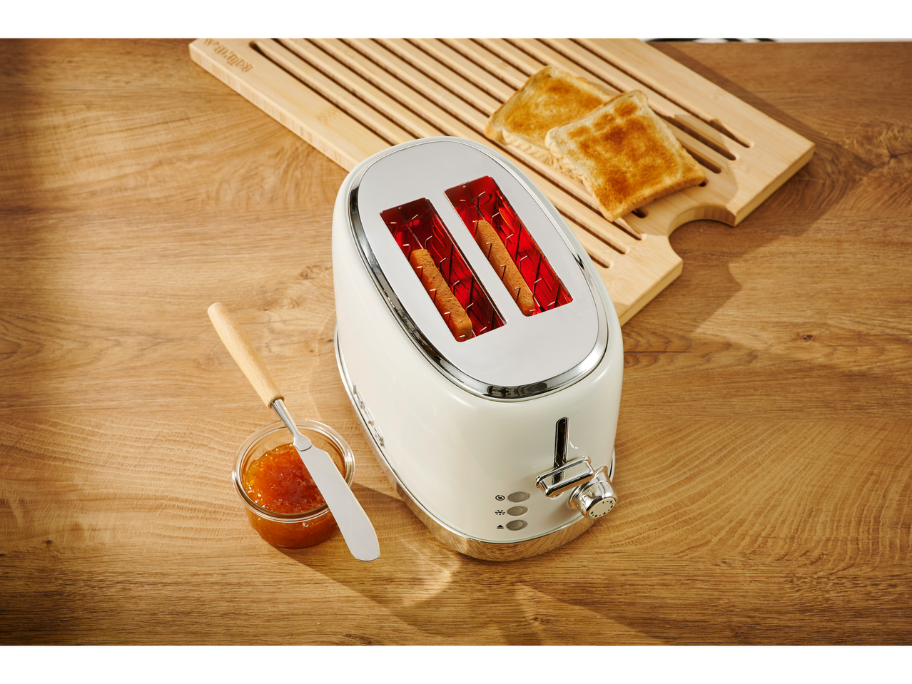 SILVERCREST® toaster with toast and jam on a wooden table.