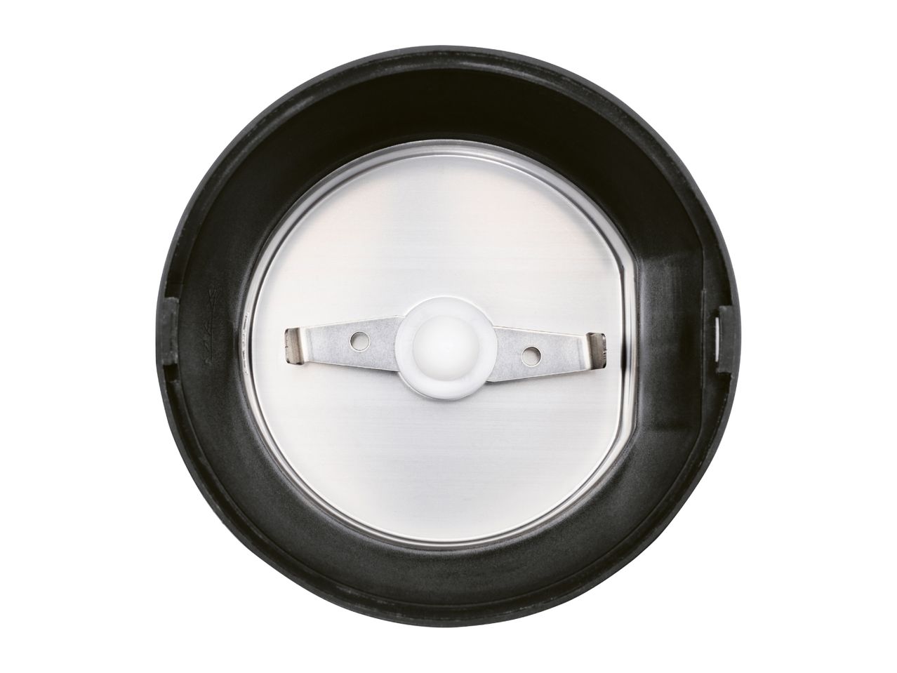 Top-down view of a coffee grinder's interior with a stainless steel blade.