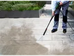 Man cleaning a patio with a Parkside® pressure washer.