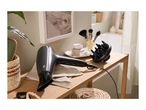 Hair dryer with diffuser and hairbrush on a wooden shelf in a bathroom setting.