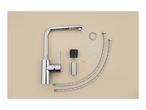 Kitchen faucet with installation parts: hoses, washers, and tools.