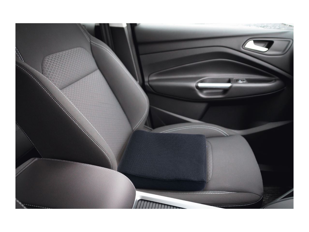 Black car seat cushion on a car seat with white stitching