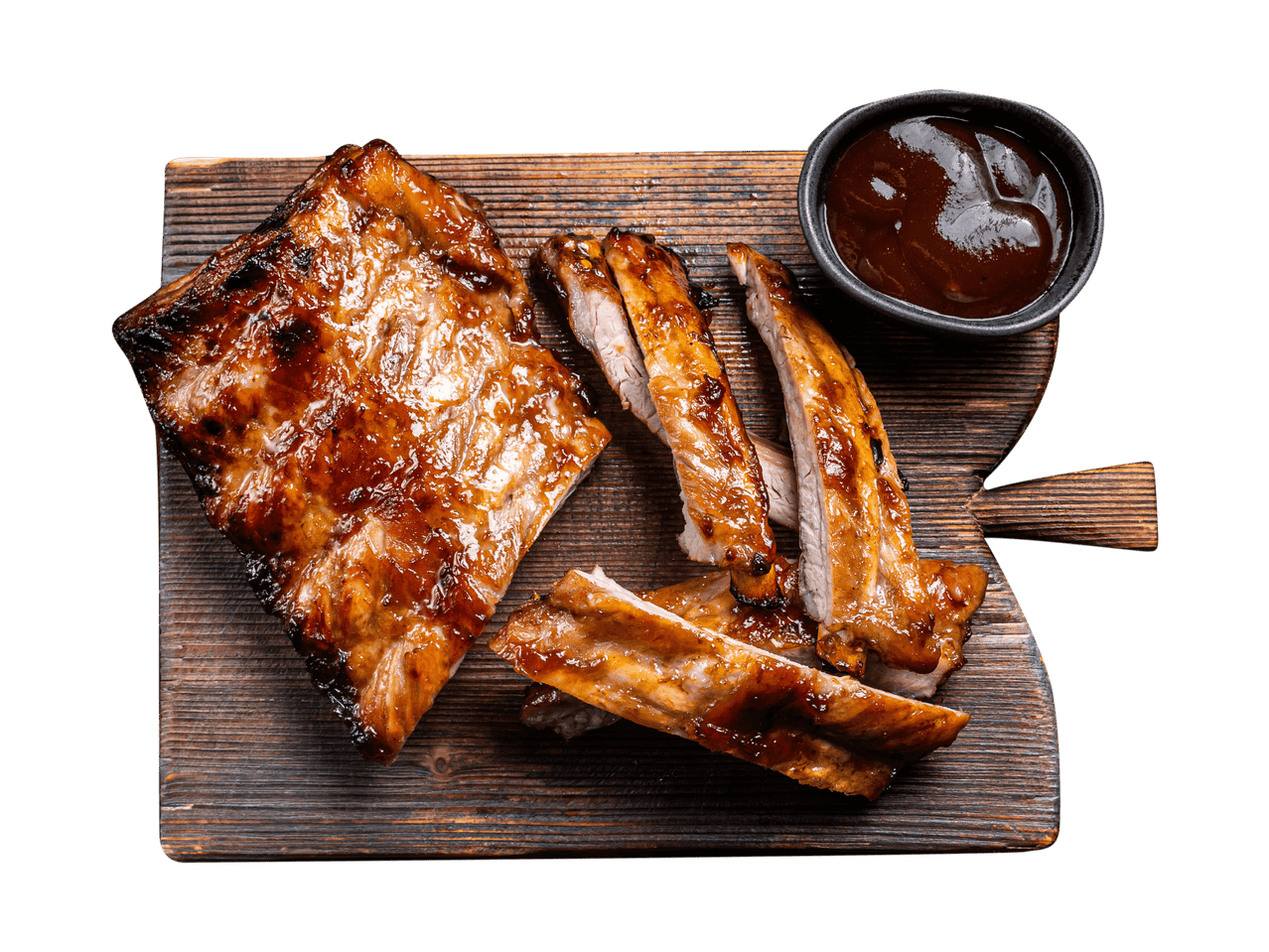 Glasierte Rippchen mit Barbecue-Sauce auf einem Holzbrett.