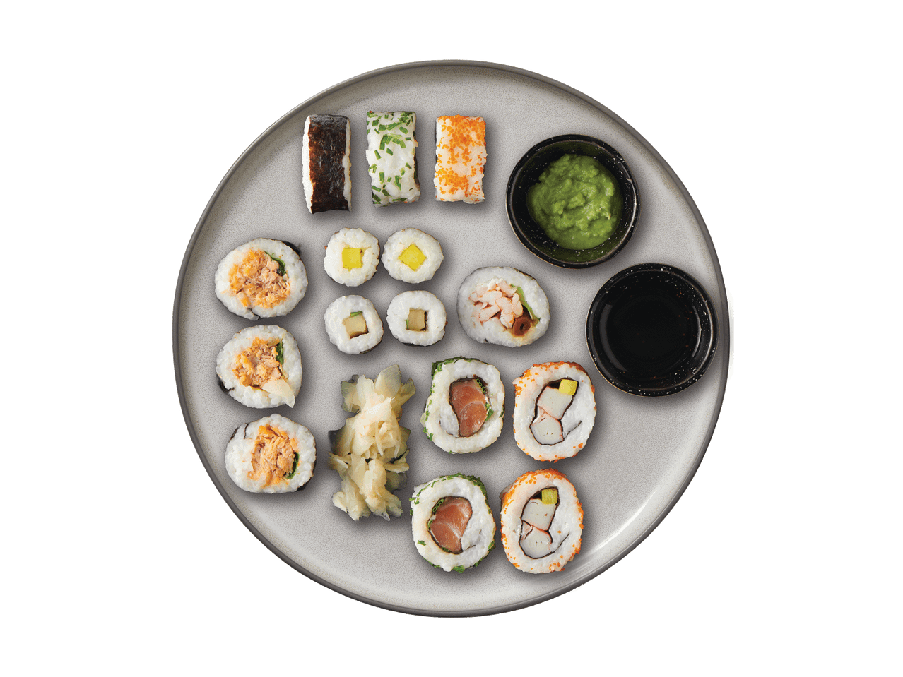 Sushi ja rullide valik koos wasabi, sojakastme ja marineeritud ingveriga taldrikul.