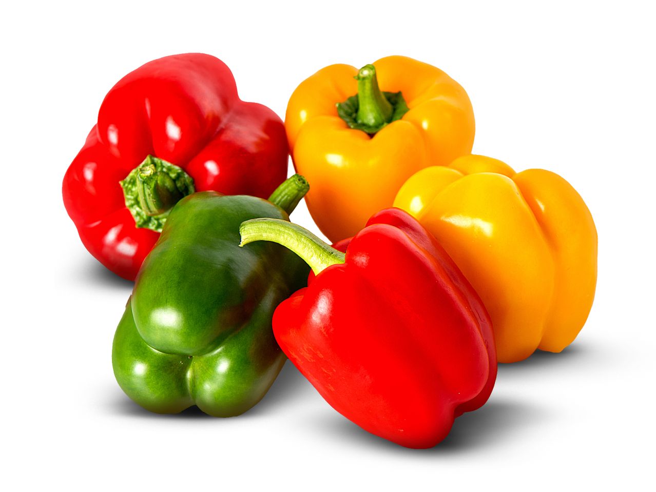 A group of red, green, and yellow bell peppers on a white background.