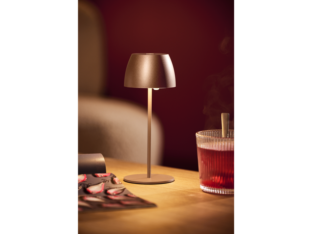 LIVARNO home cordless LED table lamp on a wooden table with a drink.