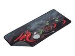 A rectangular black placemat features a vibrant chili pepper and spice design.