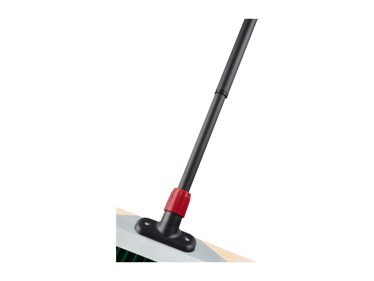 Close-up of a broom with a black handle and red connector, attached to a light-colored head.